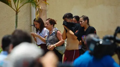 AFP/Getty People walk outside the school