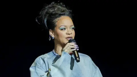 Getty Images Rihanna attended the convention to announce her role as Smurfette in The Smurfs movie