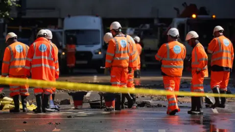 PA Media Thames Water officials working in London