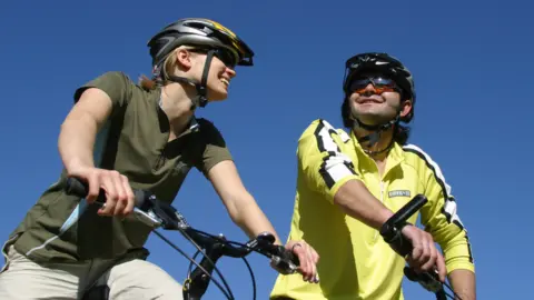 Getty Images Woman and man on bicycles