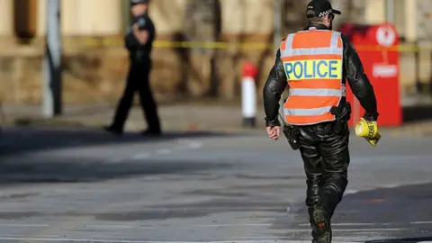 Getty Images A police officer cordons off King William Street in Adelaide, Australia