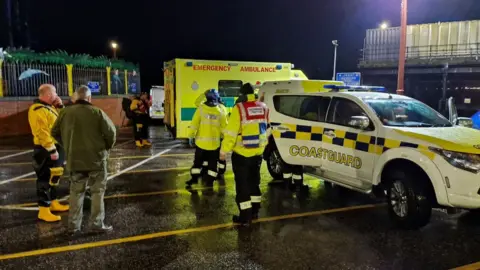 RNLI Emergency workers await the arrival of a rower lost at sea