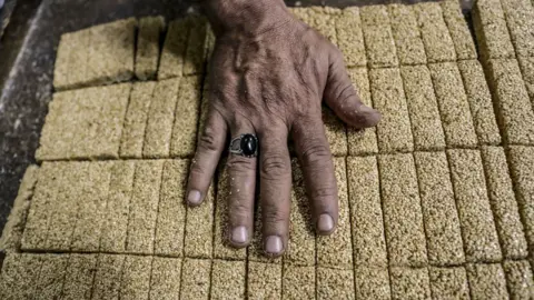 Getty Images An Egyptian confectioner shows bars of sweets with sesame at a candy factory in the capital Cairo on November 2, 2019, ahead of celebrations of the Muslim Prophet Mohammed's birthday, known as "Al Mawlid Al Nabawi". - Prophet Mohamed was born in Saudi Arabia's arid mountainous city of Mecca, the holiest in Islam, some 1490 years ago. Sunni Muslims in many parts of the world celebrate his birthday on the 12th day of the third month of the Islamic calendar, which will fall this year on November 9th.
