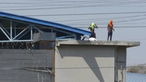 EPA Several inmates remain on the roofs of the Litoral prison in Guayaquil, Ecuador, 28 September 2021.