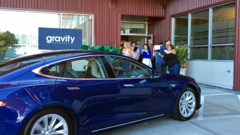 YouTube Dan Price with Alyssa O'Neal, accepting his Tesla