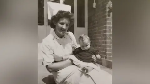 Family handout/Facebook Nurse Marjorie Try (formerly Dodd) holding a baby