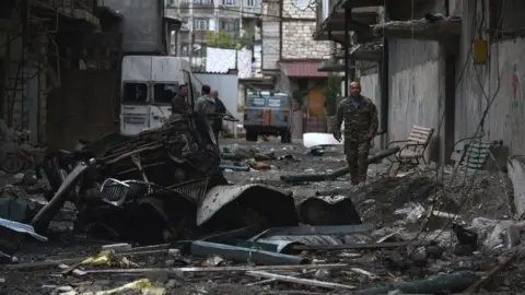 Getty Images A view shows the aftermath of recent shelling during the ongoing fighting between Armenia and Azerbaijan over the breakaway Nagorno-Karabakh region, in the disputed region's main city of Stepanakert