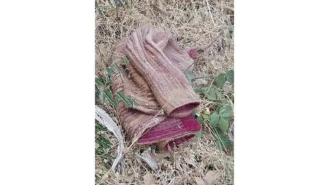 Lucie Blackman Trust Light coloured jacket on the ground