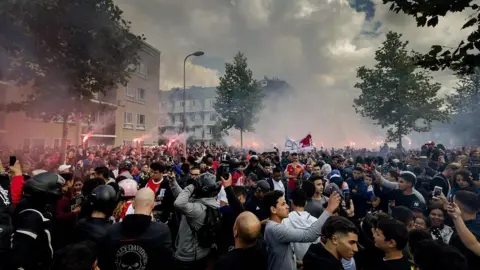 AFP Ajax fans gather outside of the family home of Dutch midfielder Abdelhak Nouri on July 14, 2017 in Amsterdam
