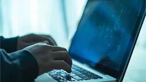 Getty Images Person typing on keyboard