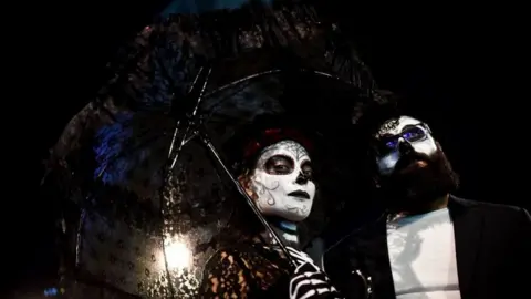 AFP A couple pose for a photograph during the parade.