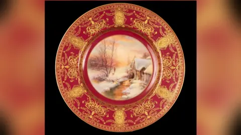 Courtesy of Chorley's A red plate with gold decoration