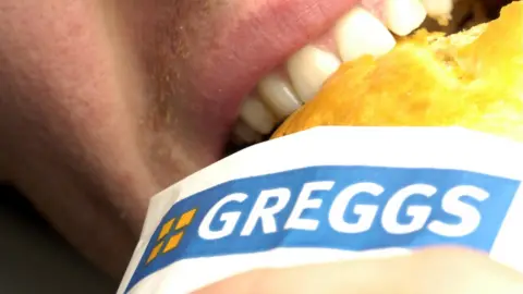 Newscast Person eating a Greggs pasty