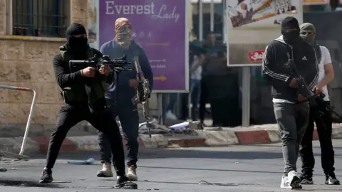 EPA Palestinian militants battle Israeli forces in Jenin, in the occupied West Bank (3 July 2023)