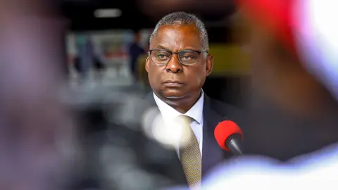 EPA US Secretary of Defense Lloyd Austin dressed in a suit looking away during a press conference in Kenya in September