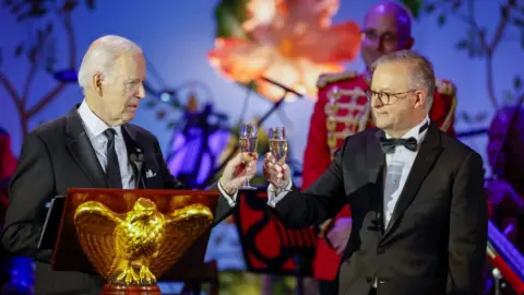 Getty Images President Joe Biden and Prime Minister of Australia Anthony Albanese toast before the start of the state dinner to the White House on October 25, 2023 in Washington, DC