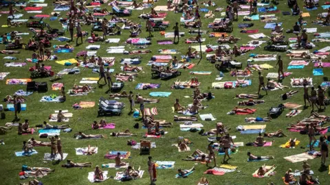 EPA People sunbathe in a park in Prague as temperatures reach 38C in parts of the Czech Republic, 1 August 2017