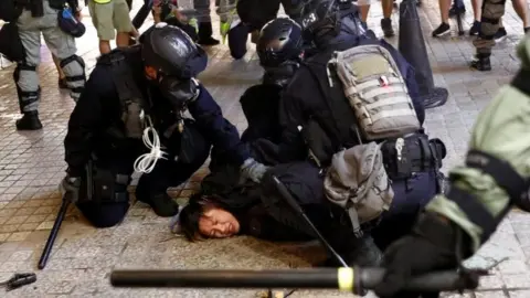 Reuters Police detain a demonstrator in Hong Kong. Photo: 31 August 2019