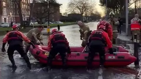 London Fire Brigade using a boat to rescue people