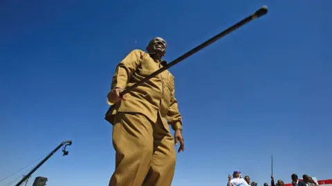 Getty Images President Omar al-Bashir holding a stick in Khartoum, Sudan - Wednesday 9 January 2019