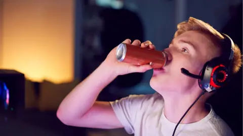 Getty Images Boy drinking from a can