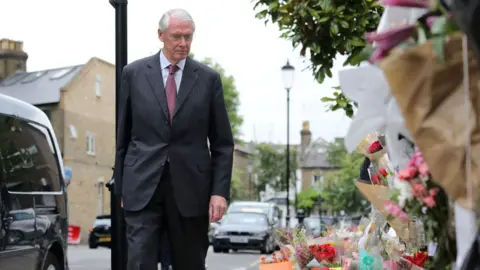 Getty Images Sir Martin Moore-Bick looking at tributes left near Grenfell Tower