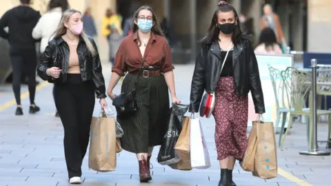 Getty Images Shoppers wearing face masks