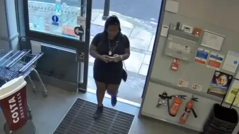 Durham Police/CPS Still from CCTV footage of a woman walking into a shop