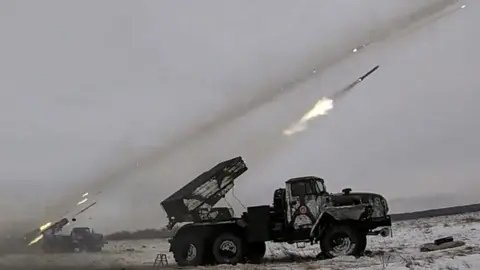 EPA/Russian defence ministry Russian Defence ministry press service on 16 December 2021 shows Russian BM-21 "Grad" a Soviet truck-mounted 122 mm multiple rocket launchers shoot during military drills near Orenburg, Russia, 16 December 2021