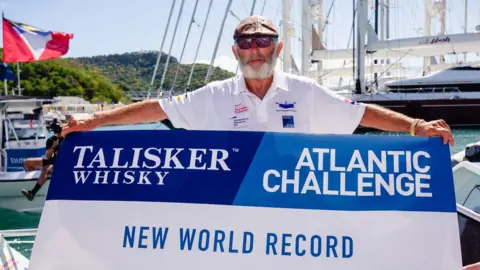 PA Media Frank Rothwell with world record sign