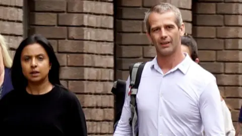 BBC Shiza and Sean Harper outside of Chelmsford Crown Court, Shiza is dressed in a black top and Sean in a white shirt 