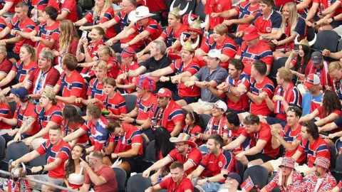 Getty Images Norway fans in their national kit row during the first half of a FIFA World Cup match between Ivory Coast and Norway in Arlington.