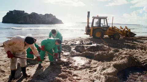 Getty Images Volunteers clean Castle Beach in Tenby 