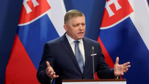  Slovak Prime Minister Robert Fico speaks at a joint press conference Hungary with Slovakian flag behind him, in January 2024