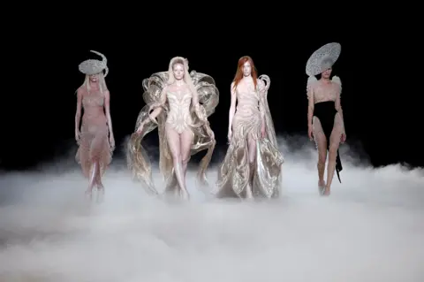Benoit Tessier/REUTERS Models present creations by designer Iris van Herpen as part of her Haute Couture Fall/Winter 2026-2027 collection show in Paris, France, July 6, 2026. 