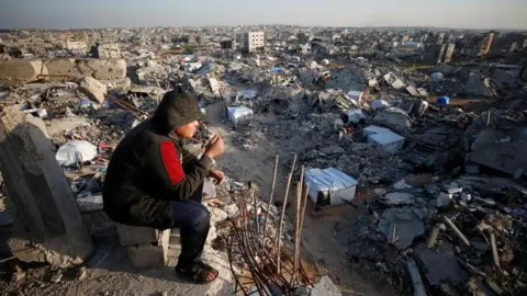 Reuters A Palestinian looks on as the rubble of destroyed buildings is seen at Jabalia refugee camp, northern Gaza Strip