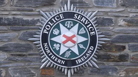 PA Media PSNI crest.