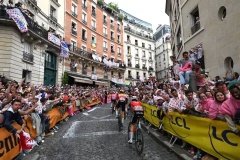 Getty Images Packed streets greet the Tour de France as racers make their way up a cobbled street in France