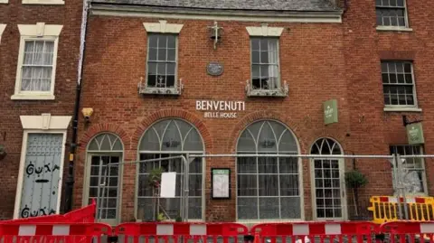 Building surrounded by temporary fencing