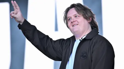 Lewis Capaldi gives the peace sign on stage at Glastonbury