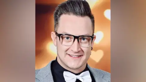 Supplied A man in glasses wearing a bow tie smiling at the camera