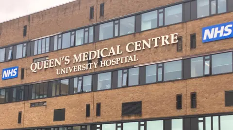 The Queen's Medical Centre signage on the side of the building