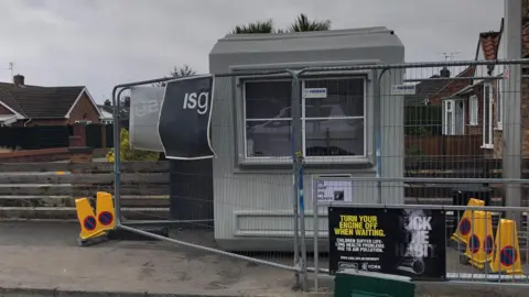 Naj Modak/BBC Temporary office on building site