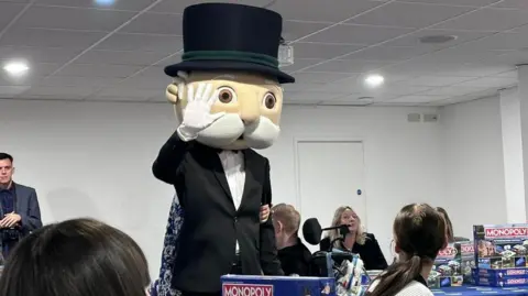 Susan Broccoli / We Love Peterborough  Mr Monopoly statue- wearing a black suit with white shirt and a black top hat 