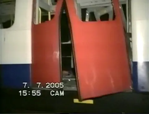 7/7 Bombings - Coroner's Inquest handout via PA Photos Screen grab taken from video footage taken by emergency services of the scene of wreckage and debris of a train at Aldgate tube station in London, after a bomb blast during the July 7 attacks. The Tube carriage door is broken, with the windows no longer intact.