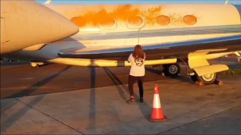 Just Stop Oil Climate-activist spray-painting aircraft with orange paint