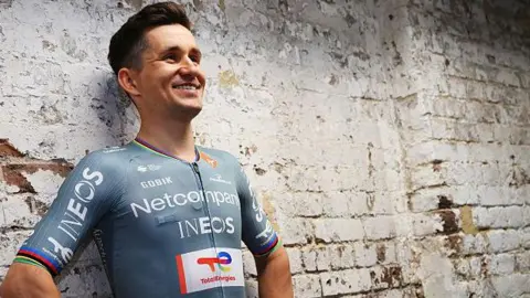 Michal Kwiatkowski models the new Netcompany-Ineos Cycling Team jersey