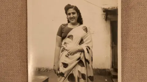 Courtesy Thaha Ibrahim A black-and-white photo of a young Sarah Cohen, dressed in a light-coloured saree with a design of leaves
