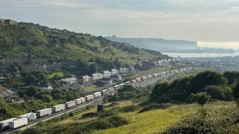 Phil Harrison/BBC Lorries are seen queuing in to Dover