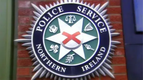 BBC A police service of northern ireland crest, mounted on a wall